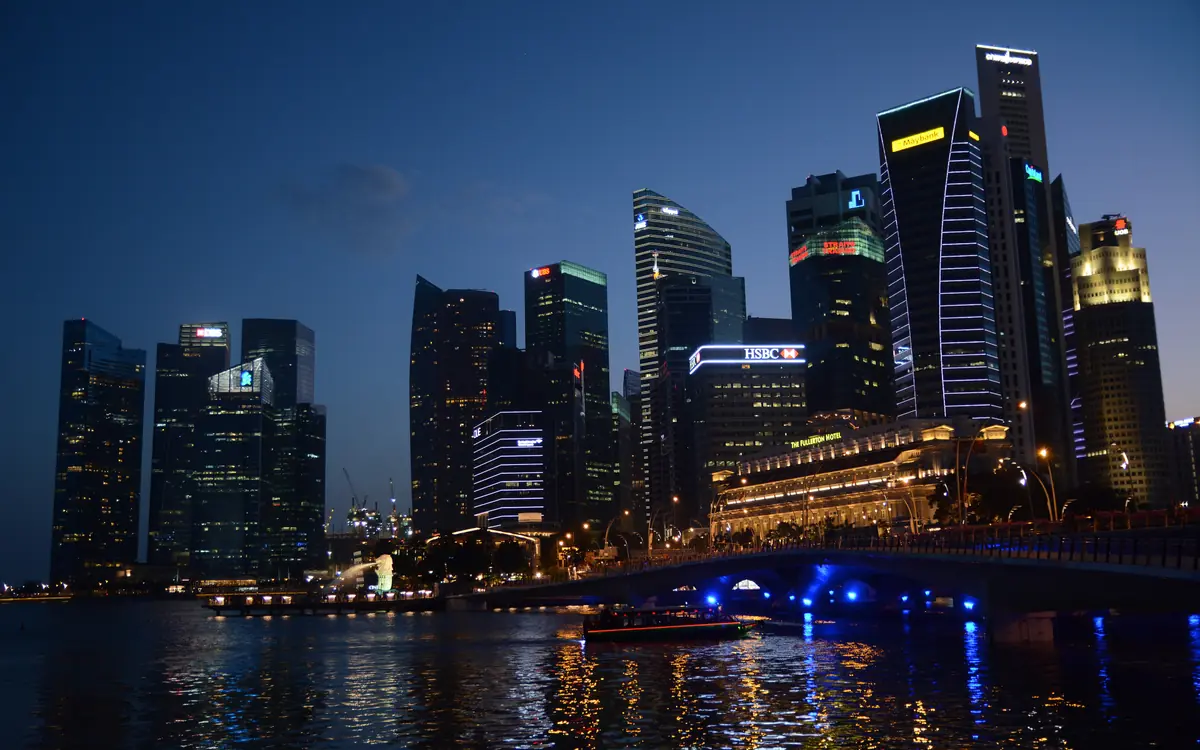 The Central Business District after dark, with lit office towers and the Fullerton Hotel beside the water